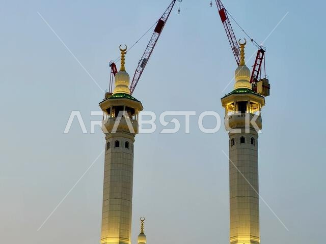 Mecca, Saudi Arabia, June 5 2024: Minarets of Al Masjid Al Haram mosque around the Kaaba in Hajj, pilgrimage, Umrah, with crane towers around it for m