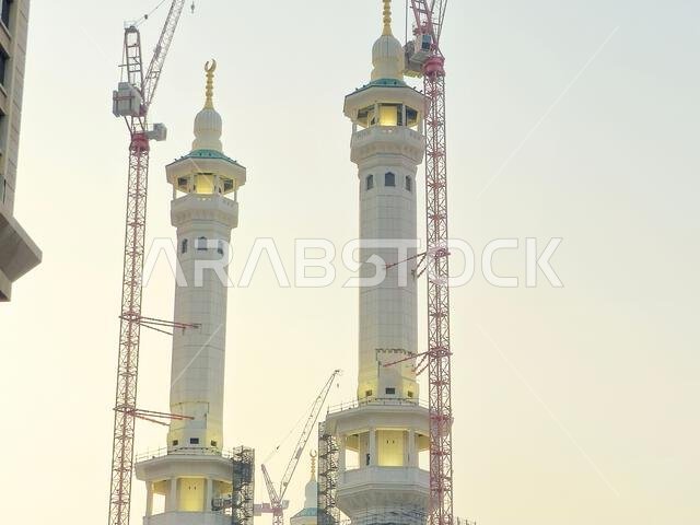 Mecca, Saudi Arabia, June 4 2024: Minarets of Al Masjid Al Haram mosque around the Kaaba in Hajj, pilgrimage, Umrah, with crane towers around it for m