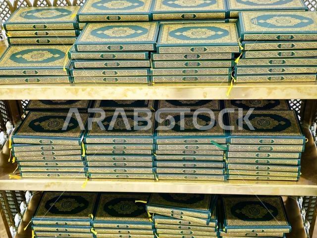 Translation of the Arabic text (Holy Quran), Stacks of holy Quran book, Islamic Noble Koran, Inside Al Masjid Al Haram mosque in Mecca Makkah city, (t