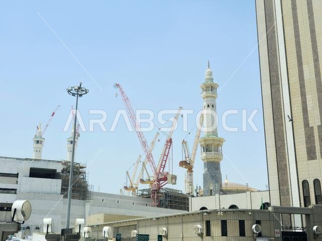 Mecca, Saudi Arabia, June 4 2024: Minarets of Al Masjid Al Haram mosque around the Kaaba in Hajj, pilgrimage, Umrah, with crane towers around it for m