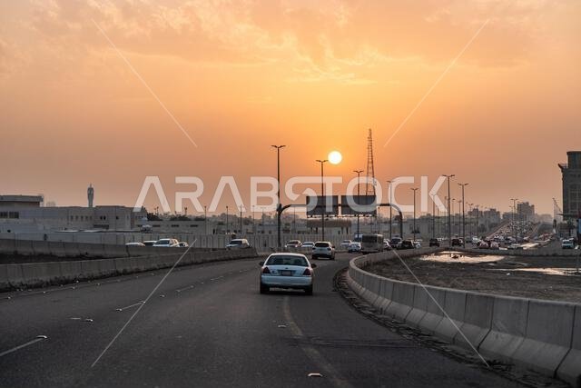 JEDDAH, SAUDI ARABIA - NOVEMBER 14, 2021: Sunset over a highway in Jeddah, Saudi Arabia JEDDAH, SAUDI ARABIA - NOVEMBER 14, 2021: Sunset over a highway in Jeddah, Saudi Arabia