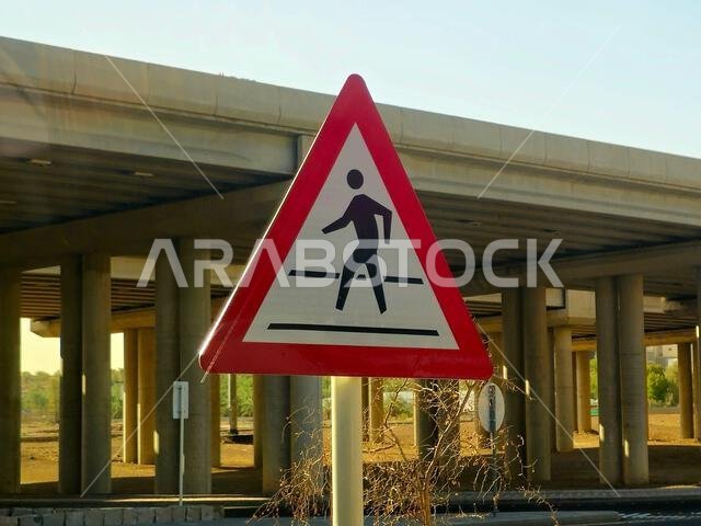pedestrian warning sign in Madinah city in Saudi Arabia kingdom country, warning sign predominantly used to warn motorists of possible pedestrian conf pedestrian warning sign in Madinah city in Saudi Arabia kingdom country, warning sign predominantly used to warn motorists of possible pedestrian conf