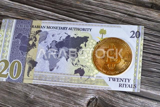 Saudi Arabia riyals banknote with Bitcoin physical golden coin, BTC the 1st decentralized cryptocurrency, nodes in P2P bitcoin network verify transact
