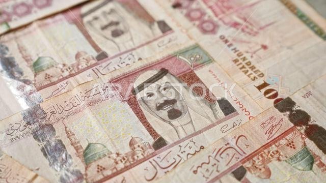 Saudi arabian banknotes featuring various denominations of riyals prominently displayed in a detailed closeup showcasing the intricate design and curr Saudi arabian banknotes featuring various denominations of riyals prominently displayed in a detailed closeup showcasing the intricate design and curr