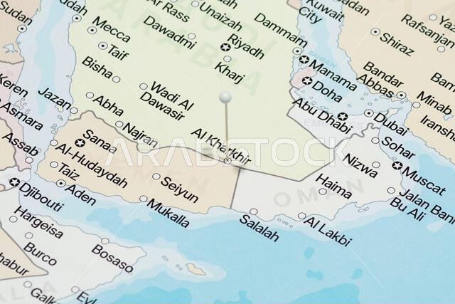 Macro photo of a white pin needle into Al Kharkhir city of Saudi Arabia political map