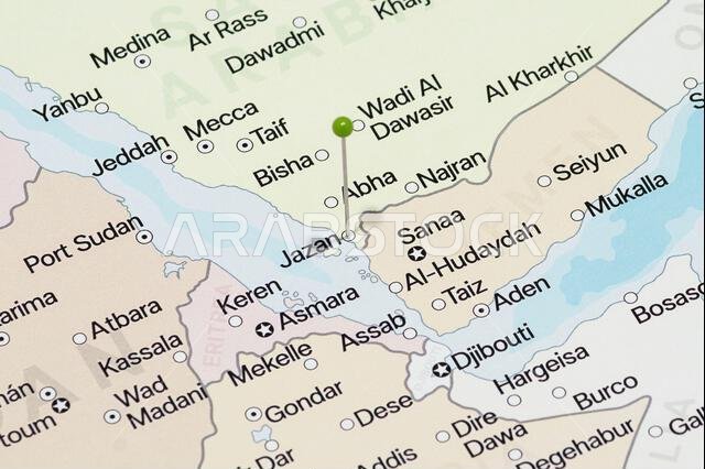 Macro photo of a green pin needle into Jazan city of Saudi Arabia political map