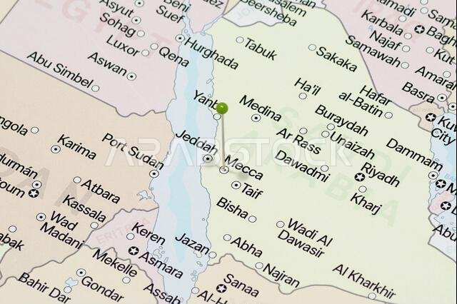 Macro photo of a green pin needle into Mecca city of Saudi Arabia political map