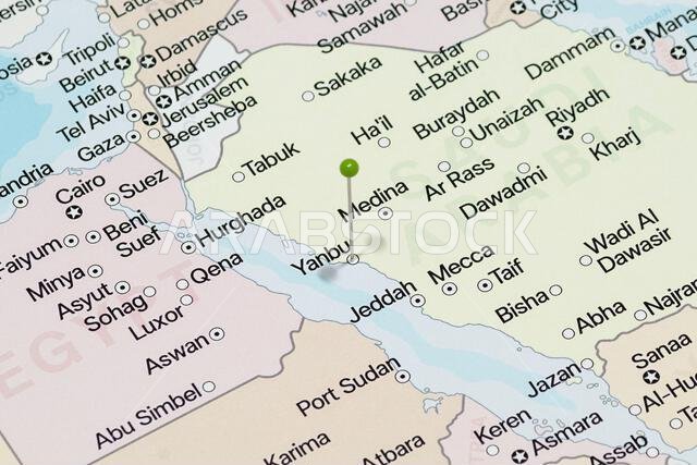 Macro photo of a green pin needle into Yanbu city of Saudi Arabia political map