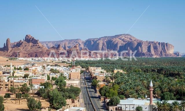 العلا، المملكة العربية السعودية، 3 أبريل 2024. منظر علوي لمركز مدينة العلا مع أشجار النخيل والجبال الصخرية في يوم مشمس.