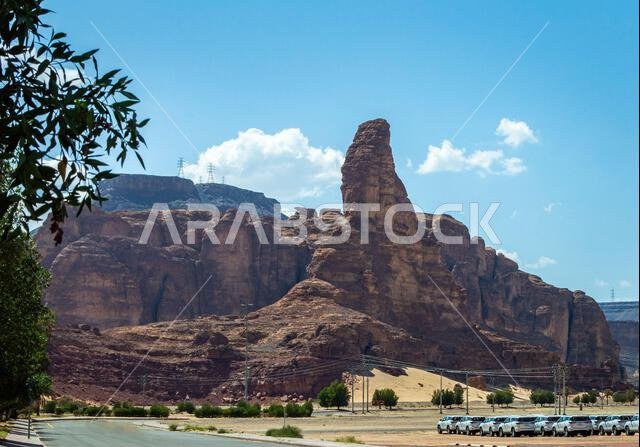 Alula, Saudi Arabia, April 3, 2024. View of Alula Winter Park road and car parking area with the rock mountains at background in a sunny day.