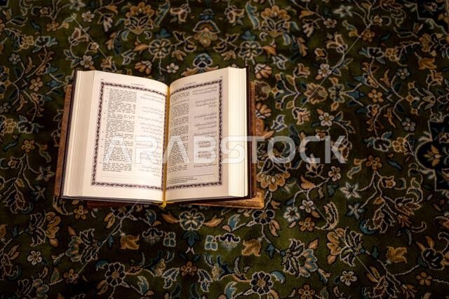 The holy book of the Quran is opened on a green carpet at the Prophet Mosque, Masjid Nabawi in the city of Medina, Saudi Arabia.