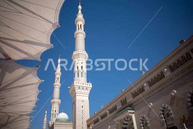 The giant automatic Umbrellas and minarets in Prophet Mosque in Madinah, also known as Masjid Nabawi, Saudi Arabia.