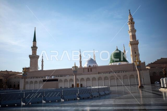 A green dome and minarets in Prophet Mosque in Madinah, also known as Masjid Nabawi, in Saudi Arabia.