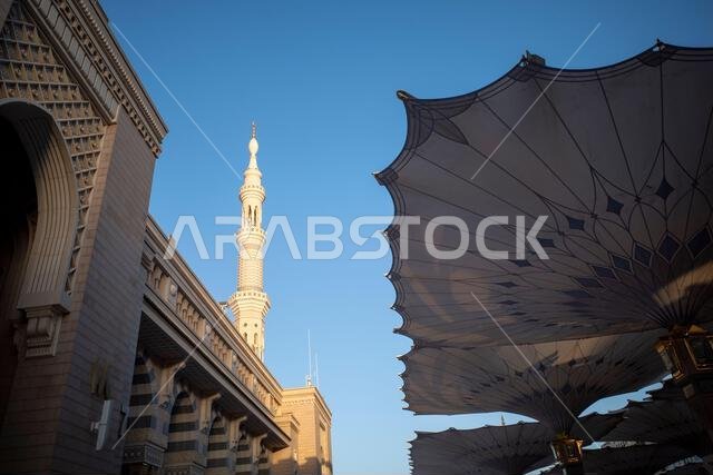 The giant automatic Umbrellas and minarets in Prophet Mosque in Madinah, also known as Masjid Nabawi, Saudi Arabia.
