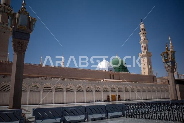 A green dome and minarets in Prophet Mosque in Madinah, also known as Masjid Nabawi, in Saudi Arabia.