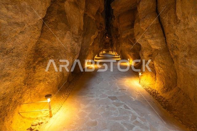 أضواء دافئة تضيء جدران الحجر الرملي داخل كهوف جبل القره، وهي أعجوبة جيولوجية في الأحساء، شرق المملكة العربية السعودية، مما يخلق أضواء دافئة تضيء جدران الحجر الرملي داخل كهوف جبل القره، وهي أعجوبة جيولوجية في الأحساء، شرق المملكة العربية السعودية، مما يخلق
