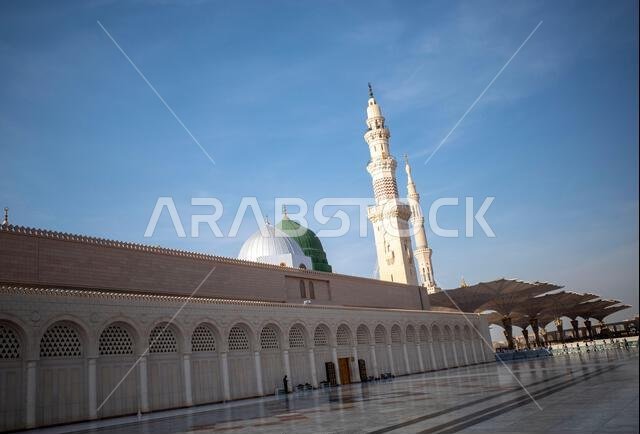 A green dome and minarets in Prophet Mosque in Madinah, also known as Masjid Nabawi, in Saudi Arabia.