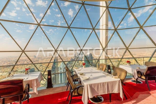 Riyadh , Saudi Arabia - Jannuary 8, 2025: Elegant dining setting in the Globe sky-bar restaurant of Al Faisaliah Tower, offering breathtaking Riyadh , Saudi Arabia - Jannuary 8, 2025: Elegant dining setting in the Globe sky-bar restaurant of Al Faisaliah Tower, offering breathtaking