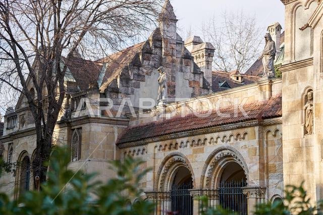 the wall of the ancient castle looks out from the bushes