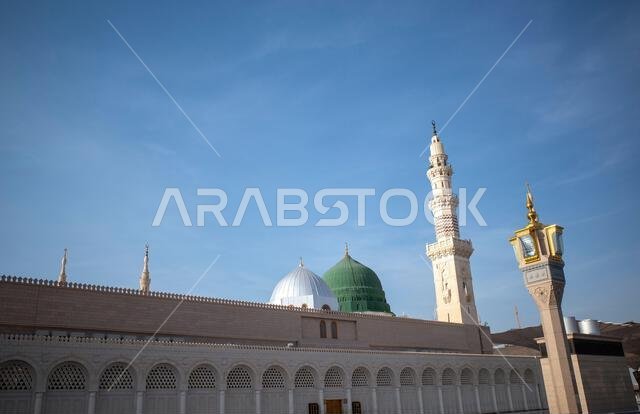 A green dome and minarets in Prophet Mosque in Madinah, also known as Masjid Nabawi, in Saudi Arabia.