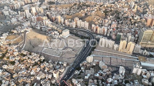 Mecca , Saudi Arabia Mars 30 2024: Makkah city Streets hotels and transportation Makkah Clock Tower - Masjid Al Haram drone aerial view