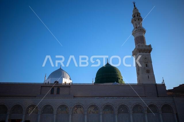 A green dome and minarets in Prophet Mosque in Madinah, also known as Masjid Nabawi, in Saudi Arabia.