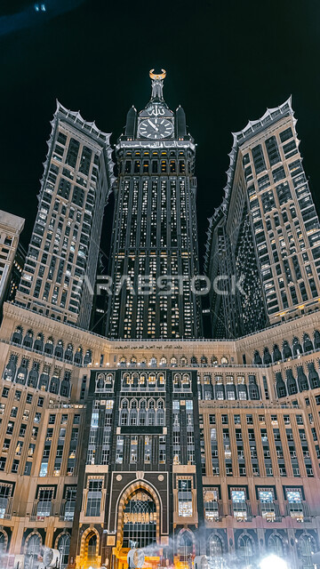 Aesthetic image from inside the Grand Mosque in Mecca, the Royal Clock Tower building at night, performing Hajj and Umrah, worship and getting closer to God, Islamic religious landmarks in the Kingdom of Saudi Arabia