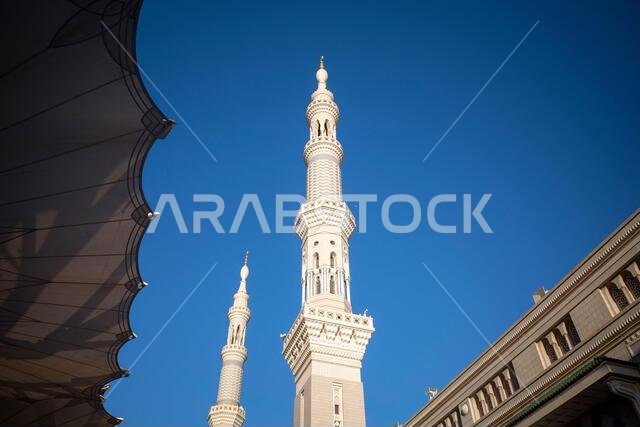 The giant automatic Umbrellas and minarets in Prophet Mosque in Madinah, also known as Masjid Nabawi, Saudi Arabia.
