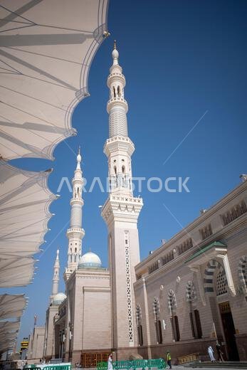 Medina, Saudi Arabia - June 29, 2024: The giant automatic Umbrellas and minarets in Prophet Mosque in Madinah, also known as Masjid Nabawi, Saudi Arab