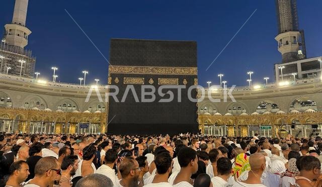 Muslim pilgrims perform Tawaf around the Kaaba after dawn prayer at Masjid al-Haram in Makkah. Translation: Praise be to Allah Who created the heavens