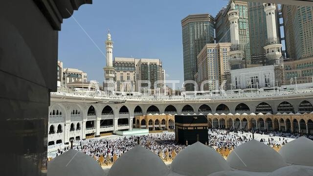 Muslim pilgrims perform Tawaf around the Kaaba after dawn prayer at Masjid al-Haram in Makkah. Translation: Praise be to Allah Who created the heavens