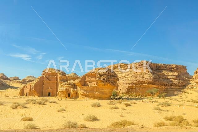 Al-Khuraymat Archaeological Site in sandstone mountains towering over the ancient city of Hegra in Al-Ula, Saudi Arabia, featuring intricate rock-cut