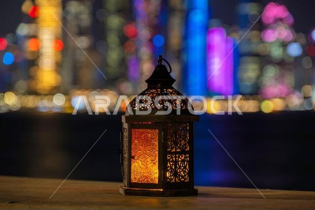 Lantern with dusk sky and Doha Skyline bokeh light background for the Muslim feast of the holy month of Ramadan Kareem