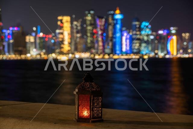 Lantern with dusk sky and Doha Skyline bokeh light background for the Muslim feast of the holy month of Ramadan Kareem