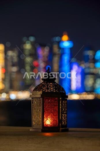 Lantern with dusk sky and Doha Skyline bokeh light background for the Muslim feast of the holy month of Ramadan Kareem