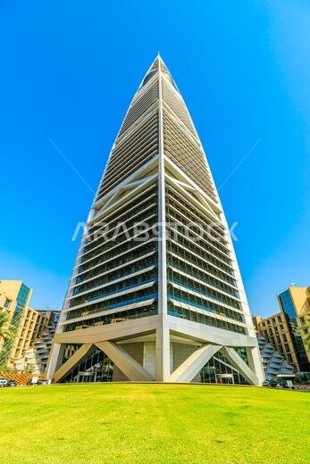 Riyadh , Saudi Arabia - Jannuary 8, 2025: Modern skyscraper of Kingdom Centre rising majestically in Riyadh, set against a vibrant blue sky