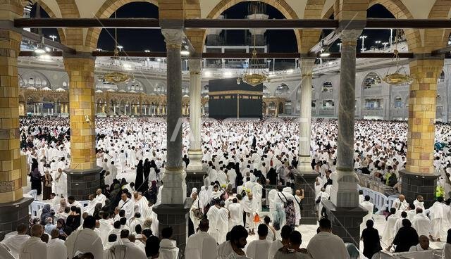 Muslim pilgrims perform Tawaf around the Kaaba after dawn prayer at Masjid al-Haram in Makkah. Translation: Praise be to Allah Who created the heavens