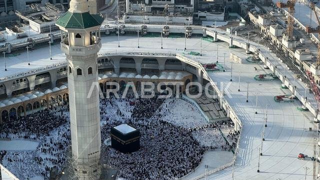 Aerial view of Masjid Al-Haram and Makkah city from the Clock Tower, Pilgrims performing Tawaf around the Kaaba during Hajj or Umrah, Magrib pray. The