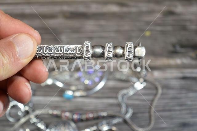 Translation of Arabic of Quran verse (Indeed, we have granted you a clear victory) and Allah word on a silver Kaaba Ka'bah key model, silver model of Translation of Arabic of Quran verse (Indeed, we have granted you a clear victory) and Allah word on a silver Kaaba Ka'bah key model, silver model of