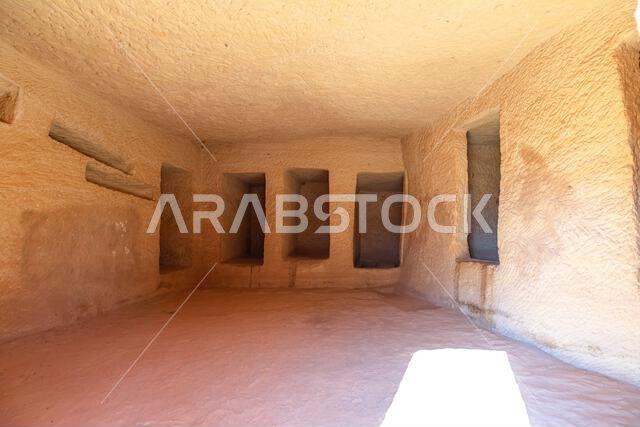 Jabal AlBanat with the interior of a rock-cut tomb in Hegra, Al-Ula, Saudi Arabia, showcasing burial niches and ancient architecture, offering a