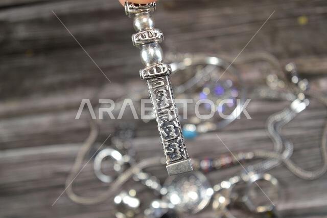 Translation of Arabic of Quran verse (Indeed, we have granted you a clear victory) and Allah word on a silver Kaaba Ka'bah key model, silver model of Translation of Arabic of Quran verse (Indeed, we have granted you a clear victory) and Allah word on a silver Kaaba Ka'bah key model, silver model of