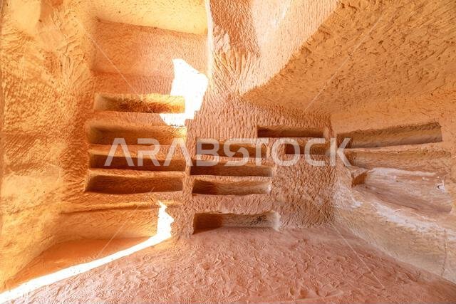 Sunlight illuminating the interior of a rock-cut tomb Jabal Al-Banat in Hegra, Al-Ula, Saudi Arabia, reveals intricate details and ancient burial