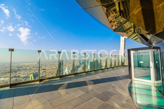 Offering breathtaking panoramic views of Riyadh's skyline, rooftop features modern architecture, glass railings, and reflective surfaces under a clear Offering breathtaking panoramic views of Riyadh's skyline, rooftop features modern architecture, glass railings, and reflective surfaces under a clear