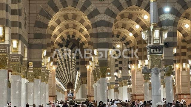 A Muslim pilgrim praying inside the grand Masjid al-Haram in Mecca, Saudi Arabia. The holy Kaaba, Islamic architecture, and religious symbols create a