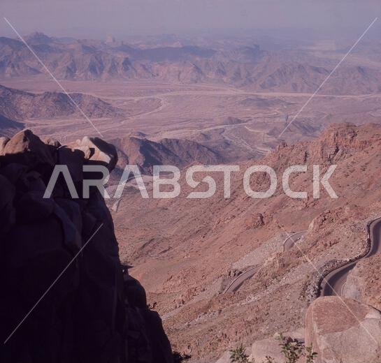 1960s, historical, a view across Al Hada mountains, Taif, Saudi Arabia. Mecca can be seen from this viewpoint, which is reached by a winding mountain road, parts which can be seen on the lower right of the picture.