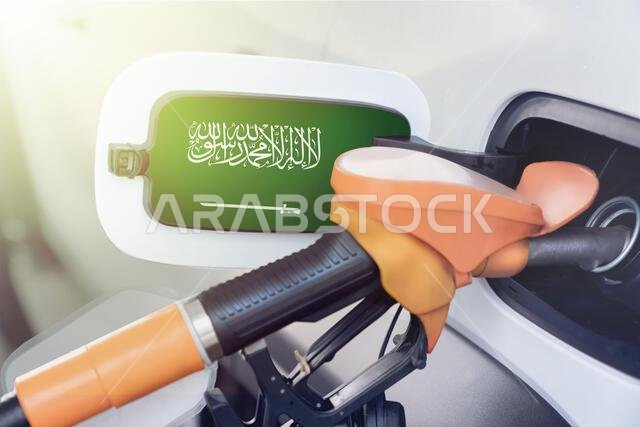The flag of Saudi Arabia on the lid of the gas tank of a car at a gas station in close-up. High or low prices for gasoline and diesel fuel at gas stat