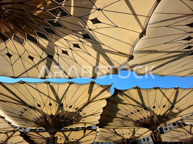 The tents at the prophet's mosque or Al Masjid Al Nabawi in Madinah at the outer courtyard to provide shade to pilgrims, a major site of pilgrimage, o The tents at the prophet's mosque or Al Masjid Al Nabawi in Madinah at the outer courtyard to provide shade to pilgrims, a major site of pilgrimage, o
