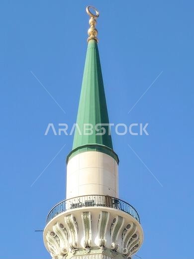 The green topped minaret of The Prophet's Mosque or Al Masjid Al Nabawi, major site of pilgrimage in Madinah city that falls under the purview of the