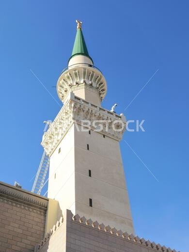 The green topped minaret of The Prophet's Mosque or Al Masjid Al Nabawi, major site of pilgrimage in Madinah city that falls under the purview of the