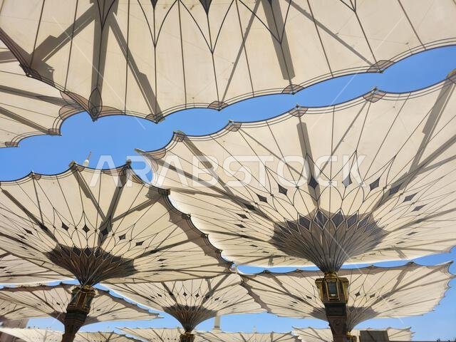 The tents at the prophet's mosque or Al Masjid Al Nabawi in Madinah at the outer courtyard to provide shade to pilgrims, a major site of pilgrimage, o The tents at the prophet's mosque or Al Masjid Al Nabawi in Madinah at the outer courtyard to provide shade to pilgrims, a major site of pilgrimage, o